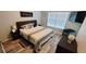 Comfortable bedroom with a king-size bed, modern decor, and plenty of natural light at 2729 Club Cortile Cir, Kissimmee, FL 34746