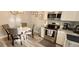 Cozy dining area features modern lighting, table, and stainless steel appliances at 2729 Club Cortile Cir, Kissimmee, FL 34746