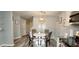 Well-lit dining area features neutral décor, table, and stainless appliances at 2729 Club Cortile Cir, Kissimmee, FL 34746