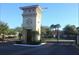 Gated community entrance with stone clock tower and black metal gate at 2729 Club Cortile Cir, Kissimmee, FL 34746