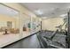Well-equipped fitness center with cardio machines and weightlifting equipment at 2729 Club Cortile Cir, Kissimmee, FL 34746