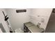 Modern laundry room with gray washer and dryer, and storage shelves at 2729 Club Cortile Cir, Kissimmee, FL 34746