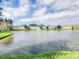Scenic view of a pond with a fountain surrounded by community townhomes at 2729 Club Cortile Cir, Kissimmee, FL 34746