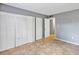 Spacious bedroom featuring tile floors, a closet with bifold doors, and a doorway at 2864 N Powers Dr # 150, Orlando, FL 32818