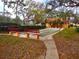 Community bocce ball court with park benches surrounded by mature landscaping at 2864 N Powers Dr # 150, Orlando, FL 32818