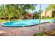 Community pool features a brick pool deck, trees, and views of the surrounding condos at 2864 N Powers Dr # 150, Orlando, FL 32818