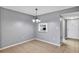 Cozy dining area featuring modern chandelier and connecting pass-through to the kitchen at 2864 N Powers Dr # 150, Orlando, FL 32818