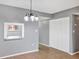 Cozy dining area featuring modern chandelier, closet, and connecting pass-through to the kitchen at 2864 N Powers Dr # 150, Orlando, FL 32818