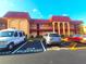 Condo exterior with reserved parking spaces and a red roof under a sunny sky at 2864 N Powers Dr # 150, Orlando, FL 32818