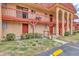 Condo complex with red roof, balconies, and parking space, showcasing its inviting design at 2864 N Powers Dr # 150, Orlando, FL 32818