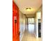 Bright condo hallway showcasing tile flooring, mirrored wall, and access to the kitchen and living areas at 2864 N Powers Dr # 150, Orlando, FL 32818