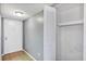 Hallway with tile floor, a white closet with bifold doors and a door to the exterior at 2864 N Powers Dr # 150, Orlando, FL 32818