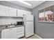Efficient kitchen featuring white cabinets, essential appliances, and durable countertop at 2864 N Powers Dr # 150, Orlando, FL 32818
