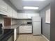 Efficient kitchen featuring white cabinets, essential appliances, and durable countertop at 2864 N Powers Dr # 150, Orlando, FL 32818