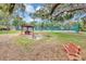 Outdoor picnic area with multiple picnic tables and barbecue under mature trees at 2864 N Powers Dr # 150, Orlando, FL 32818