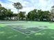 Well-maintained community tennis court surrounded by mature landscaping on a sunny day at 2864 N Powers Dr # 150, Orlando, FL 32818