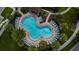 Aerial view of a resort-style pool surrounded by palm trees and lounge chairs at 2922 Crest Dr, Kissimmee, FL 34744