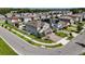 Aerial view of a modern home in a suburban neighborhood, showing well-manicured lawn and paver driveway at 2922 Crest Dr, Kissimmee, FL 34744