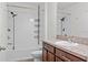 A practical bathroom has a shower-tub combo, wooden cabinets, and efficient fixtures at 2922 Crest Dr, Kissimmee, FL 34744