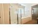 Bright bathroom with a shower and tub combo with tile surround and tiled floors at 2922 Crest Dr, Kissimmee, FL 34744