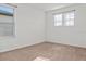 A carpeted bedroom with natural light from two windows creates an inviting space at 2922 Crest Dr, Kissimmee, FL 34744