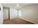 Neutral bedroom with carpet floors, a window, and a closet at 2922 Crest Dr, Kissimmee, FL 34744