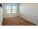 Well lit bedroom with two windows, carpeted floors, and bare walls at 2922 Crest Dr, Kissimmee, FL 34744