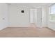 Open-concept bedroom featuring neutral carpet, natural light, closet and a clean and airy space at 2922 Crest Dr, Kissimmee, FL 34744