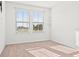 This bright bedroom features plush carpeting and plenty of natural light from two windows at 2922 Crest Dr, Kissimmee, FL 34744