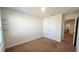 Neutral bedroom featuring carpeted floors, a window, and a double door closet at 2922 Crest Dr, Kissimmee, FL 34744
