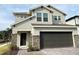 Charming two-story home featuring a two-car garage, stone accents, and a welcoming front entrance at 2922 Crest Dr, Kissimmee, FL 34744