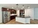 Modern kitchen with stainless steel appliances, granite countertops, and dark wood cabinets at 2922 Crest Dr, Kissimmee, FL 34744