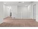 Second floor landing area with neutral carpet and white railing and trim at 2922 Crest Dr, Kissimmee, FL 34744