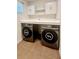 Well-organized laundry room with modern washer and dryer, storage cabinets, and stylish countertops at 2922 Crest Dr, Kissimmee, FL 34744
