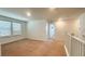 Upstairs loft with neutral carpet and natural light from the windows at 2922 Crest Dr, Kissimmee, FL 34744