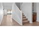 A carpeted staircase with white railing accents the home's architectural design and flow at 2922 Crest Dr, Kissimmee, FL 34744