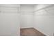 A carpeted walk-in closet with shelving offers ample storage space and organization options at 2922 Crest Dr, Kissimmee, FL 34744