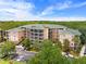Beautiful condo building surrounded by mature trees, offering an elegant exterior and convenient parking at 3060 Pirates Retreat Ct # 309, Kissimmee, FL 34747