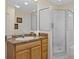 Updated bathroom featuring an enclosed glass shower and light wood cabinets at 3060 Pirates Retreat Ct # 309, Kissimmee, FL 34747