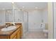 Bright bathroom featuring a shower, tub, and light wood cabinets with solid countertops at 3060 Pirates Retreat Ct # 309, Kissimmee, FL 34747
