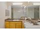 Bright bathroom features a double-sink vanity with granite countertop and modern fixtures at 3060 Pirates Retreat Ct # 309, Kissimmee, FL 34747