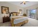 This bedroom has a queen-sized bed, sliding glass doors leading to a balcony at 3060 Pirates Retreat Ct # 309, Kissimmee, FL 34747