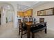 Open dining area features seating for six, flowing into a kitchen with bright wooden cabinets and modern appliances at 3060 Pirates Retreat Ct # 309, Kissimmee, FL 34747