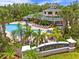 Aerial view of the Caribe Cove resort entrance, pool and clubhouse with palm trees at 3060 Pirates Retreat Ct # 309, Kissimmee, FL 34747