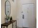 Inviting entryway featuring a stylish console table with decorations and a sleek oval mirror by the door at 3060 Pirates Retreat Ct # 309, Kissimmee, FL 34747