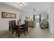 Cozy living and dining area with comfortable seating, ceiling fan, and a view from the sliding glass doors at 3060 Pirates Retreat Ct # 309, Kissimmee, FL 34747