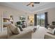 Inviting living room with neutral palette, balcony access, comfortable seating, and seamless bedroom transition at 3060 Pirates Retreat Ct # 309, Kissimmee, FL 34747