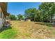Grassy backyard with a shed, trees, and fencing at 308 Forest St, Fruitland Park, FL 34731