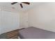 Bedroom features wood-look floors, fan, and closet at 308 Forest St, Fruitland Park, FL 34731