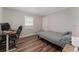 Bedroom with a bed, desk, wood floors, and a closet at 308 Forest St, Fruitland Park, FL 34731